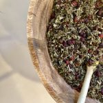 Dried Herbs for Tea inside a wooden bowl